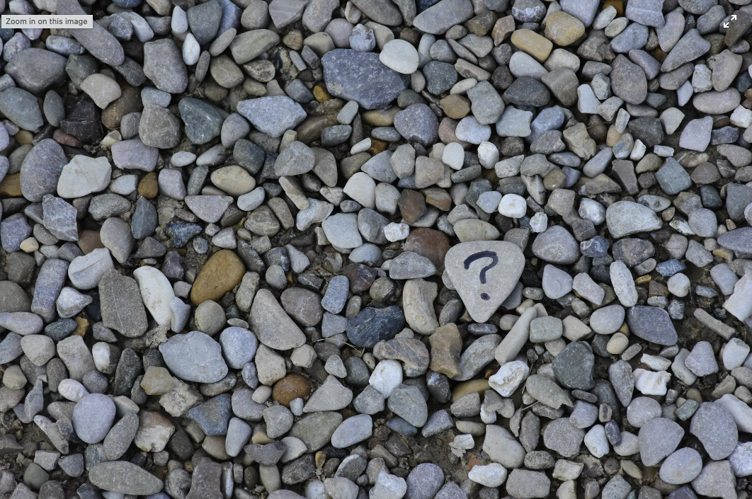 Pile of stones. One heart-shaped stone has a question mark visually representing a technical Ask Stack.